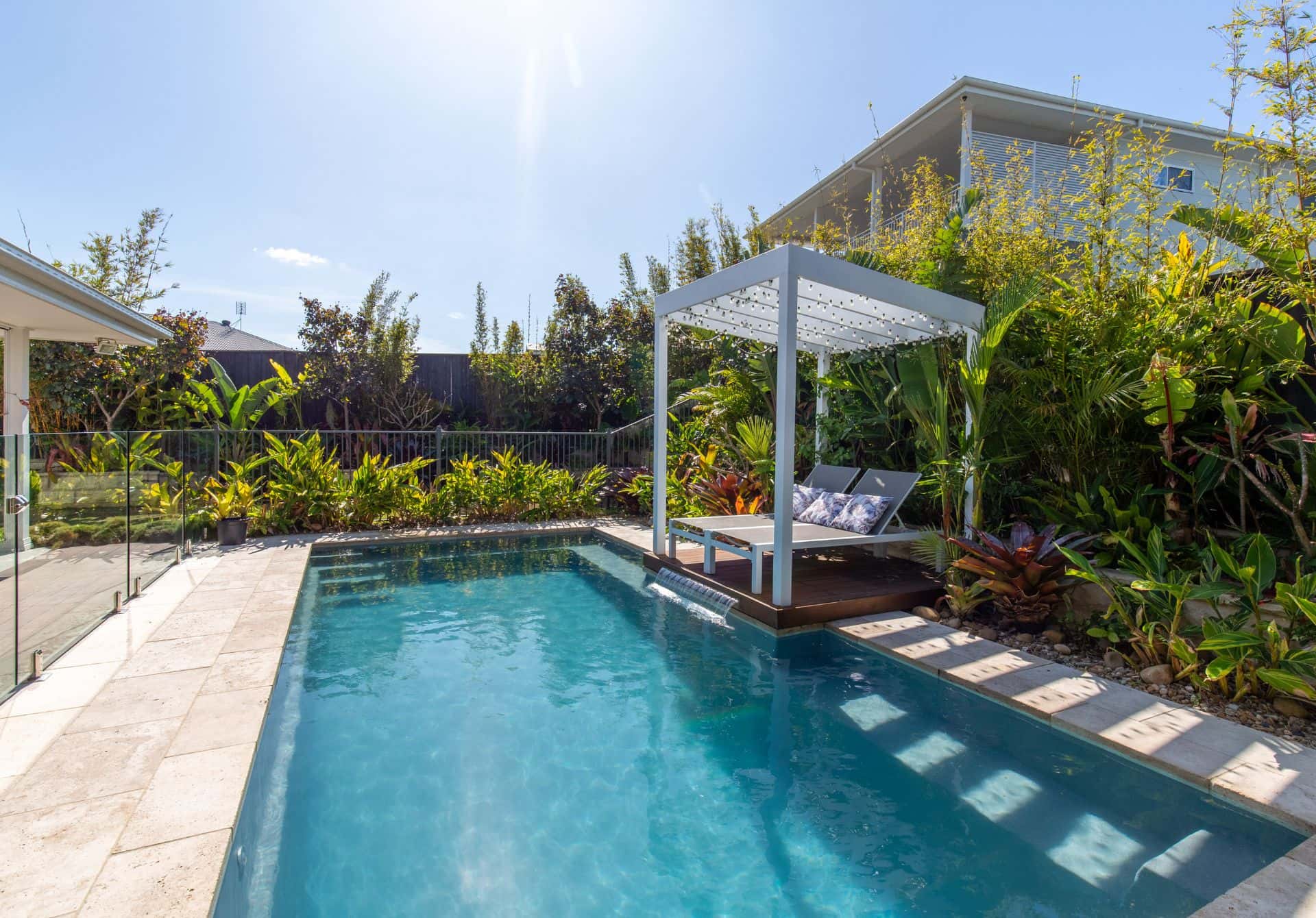 Serene pool surrounded by lush greenery.